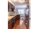 Well-lit kitchen boasts stainless steel appliances, granite countertops, and warm wood flooring at 9532 Cadman Ct, Cornelius, NC 28031