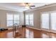 Bright living room featuring hardwood floors, ample windows, and a door leading to the backyard at 9532 Cadman Ct, Cornelius, NC 28031