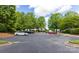 This parking lot has several parking spaces available and is surrounded by mature trees at 9532 Cadman Ct, Cornelius, NC 28031