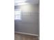 Practical walk-in closet features neutral paint, shelving, and a window for natural light at 9532 Cadman Ct, Cornelius, NC 28031