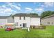 A spacious backyard featuring a deck, lawn, and slide provides an ideal outdoor space at 10016 Lawing School Rd, Charlotte, NC 28214