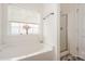 Bright bathroom featuring a soaking tub with a window and a separate shower at 10016 Lawing School Rd, Charlotte, NC 28214