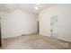 Carpeted bedroom with ensuite bath access and ample room for furniture at 10016 Lawing School Rd, Charlotte, NC 28214