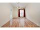 Bright dining room featuring wood floors, modern lighting, and a large window at 10016 Lawing School Rd, Charlotte, NC 28214