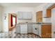 Well-lit kitchen with light colored cabinets, contrasting countertops and modern dishwasher at 10016 Lawing School Rd, Charlotte, NC 28214