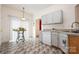 Convenient kitchen and breakfast nook area featuring a table, white appliances and neutral tones at 10016 Lawing School Rd, Charlotte, NC 28214