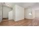 Spacious, light-filled living room featuring wood floors and staircase access at 10016 Lawing School Rd, Charlotte, NC 28214
