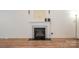 Living room featuring fireplace as focal point with wood floors at 10016 Lawing School Rd, Charlotte, NC 28214
