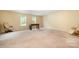 Spacious recreation room with a foosball table and a pair of comfortable lounge chairs at 10016 Lawing School Rd, Charlotte, NC 28214