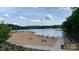 Sandy beach with people enjoying the water and sun, providing a great recreational spot at 1010 Nutall Oak Ln, Belmont, NC 28012