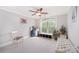 Sunny bedroom with plush carpet, ceiling fan, and a view of greenery at 1010 Nutall Oak Ln, Belmont, NC 28012