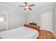 Neutral bedroom featuring hardwood floors, a ceiling fan, and simple decor at 1010 Nutall Oak Ln, Belmont, NC 28012