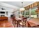 Traditional dining room with wood floors and table, enhanced by natural light from large windows at 1010 Nutall Oak Ln, Belmont, NC 28012
