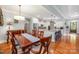 Bright dining area adjacent to kitchen showcases hardwood floors and natural light at 1010 Nutall Oak Ln, Belmont, NC 28012
