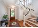 Bright foyer features hardwood floors, staircase, and a decorative front door at 1010 Nutall Oak Ln, Belmont, NC 28012