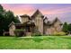 Stunning two-story brick and stone home with manicured lawn and mature landscaping at 1010 Nutall Oak Ln, Belmont, NC 28012