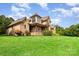 Well-maintained home features brick and stone exterior with a sprawling green lawn at 1010 Nutall Oak Ln, Belmont, NC 28012