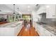 Gourmet kitchen with white cabinets, stainless appliances, and backyard views at 1010 Nutall Oak Ln, Belmont, NC 28012