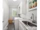 Practical laundry room features modern appliances, granite countertops and tile flooring at 1010 Nutall Oak Ln, Belmont, NC 28012