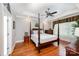 Elegant main bedroom with a four-poster bed, hardwood floors, and plenty of natural light at 1010 Nutall Oak Ln, Belmont, NC 28012