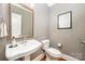 Charming powder room with a decorative mirror and classic fixtures at 1010 Nutall Oak Ln, Belmont, NC 28012