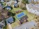 Aerial view of neighborhood amenities, including a tennis court, playground, and ample parking at 104 Steamboat Dr, Mount Holly, NC 28120