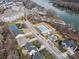 Aerial view of a neighborhood with a pool, tennis courts, lake access, and a variety of housing options at 104 Steamboat Dr, Mount Holly, NC 28120