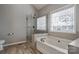 Modern bathroom with a glass-enclosed shower and a relaxing soaking tub at 104 Steamboat Dr, Mount Holly, NC 28120