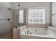 Modern bathroom with a glass-enclosed shower and a relaxing soaking tub at 104 Steamboat Dr, Mount Holly, NC 28120