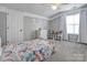 Cozy bedroom featuring a playful bedspread, neutral walls, and bright natural light at 104 Steamboat Dr, Mount Holly, NC 28120