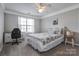 Comfortable bedroom with a ceiling fan, a window for natural light, and a well-placed desk for work at 104 Steamboat Dr, Mount Holly, NC 28120