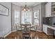 Cozy breakfast nook with bay windows, pendant lighting, hardwood floors, and modern decor at 104 Steamboat Dr, Mount Holly, NC 28120