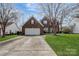 Charming brick home with a well-manicured lawn, two-car garage, and a welcoming front entrance at 104 Steamboat Dr, Mount Holly, NC 28120