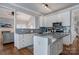 Well-designed kitchen with stainless appliances, granite countertops, white cabinets, and hardwood flooring at 104 Steamboat Dr, Mount Holly, NC 28120