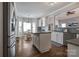 Open-concept kitchen with white cabinets, granite countertops, stainless steel appliances, and breakfast nook at 104 Steamboat Dr, Mount Holly, NC 28120