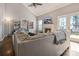 Spacious living room with fireplace, hardwood floors, vaulted ceilings, and access to the deck at 104 Steamboat Dr, Mount Holly, NC 28120