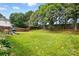 Large backyard with a grill, green grass, a wooded area and a privacy fence at 10431 Plantain Ct, Charlotte, NC 28213