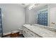 Bathroom featuring a granite vanity with sink, and a large mirror at 10431 Plantain Ct, Charlotte, NC 28213