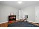 Bedroom with a book shelf, hardwood floors and a door leading outside at 10431 Plantain Ct, Charlotte, NC 28213