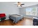 Bedroom with hardwood floors, ceiling fan, and a large window at 10431 Plantain Ct, Charlotte, NC 28213