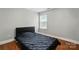 Bedroom with hardwood floors, neutral paint, and a large window at 10431 Plantain Ct, Charlotte, NC 28213