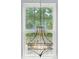 Beautiful chandelier in front of a large window with mature trees at 10431 Plantain Ct, Charlotte, NC 28213