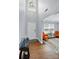 Welcoming foyer with soaring ceilings, wood floors, stylish chandelier, and a pop of color with orange chairs at 10431 Plantain Ct, Charlotte, NC 28213