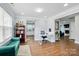 Open concept living area with hardwood floors, blue sofa and views into the adjacent kitchen at 10431 Plantain Ct, Charlotte, NC 28213