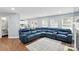 Inviting living room with hardwood floors, fireplace, large sectional sofa, and views of the kitchen at 10431 Plantain Ct, Charlotte, NC 28213