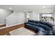 Spacious open living area featuring hardwood floors, a sectional sofa and open access to kitchen at 10431 Plantain Ct, Charlotte, NC 28213