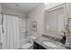 Bathroom featuring granite countertop, decorative mirror, shower-tub combo at 10906 Charmont Pl, Huntersville, NC 28078
