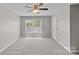 Spacious carpeted bedroom with ceiling fan and double windows for natural light at 10906 Charmont Pl, Huntersville, NC 28078