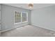 Well-lit bedroom with large windows and plush carpeting at 10906 Charmont Pl, Huntersville, NC 28078