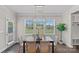 Bright dining area with backyard views, modern lighting, and neutral finishes at 10906 Charmont Pl, Huntersville, NC 28078